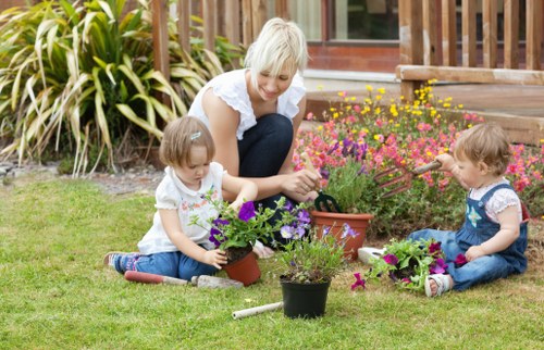 Local gardener carrying out hedge trimming and border care in Beckenham